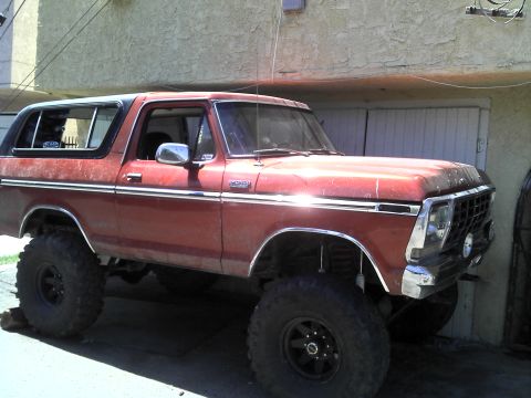 1978 Ford Bronco - This lifted 1978 Ford Bronco features a classic red exterior and prominent off-road tires.