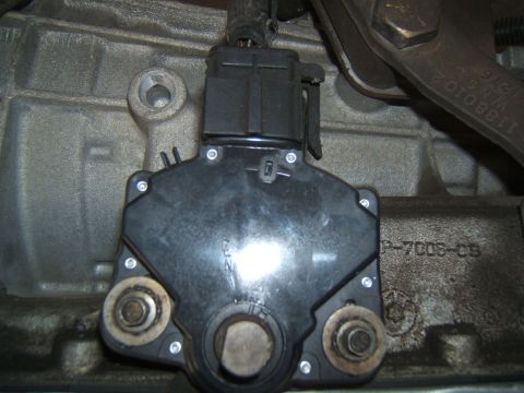 1988 Ford Bronco - Close-up of a transmission range sensor, part number P-7008-CS, attached to a transmission housing.