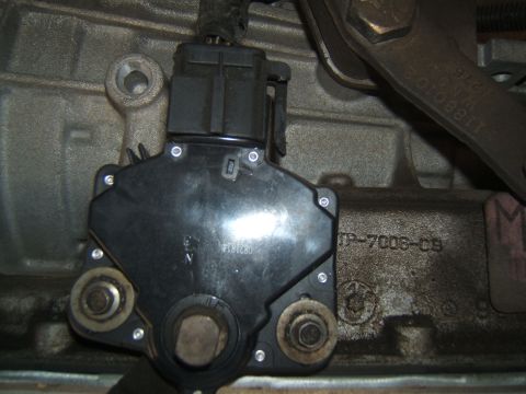 1988 Ford Bronco - Close-up of a transmission range sensor, part number JP-7006-C9, is visible on the transmission housing.