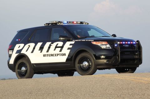 1993 Ford Taurus - A black Ford Police Interceptor Utility is parked on a roadside, equipped with a light bar and push bumper.