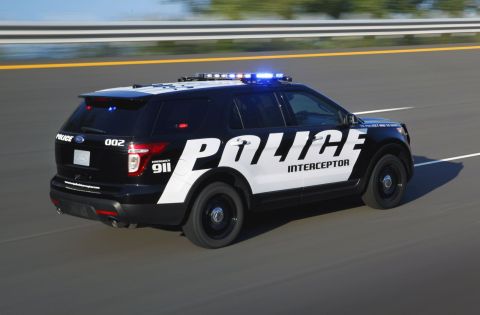 1993 Ford Taurus - Ford Police Interceptor Utility SUV with emergency lights active on a highway.