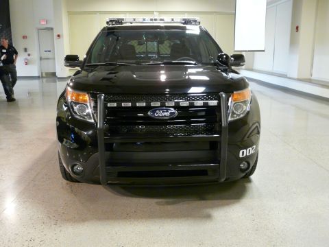 1993 Ford Taurus - Front view of a black Ford Explorer Police Interceptor equipped with a push bar and light bar.