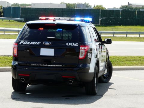 1993 Ford Taurus - Rear view of a black Ford Police Interceptor Utility vehicle equipped with a light bar and emergency lights.