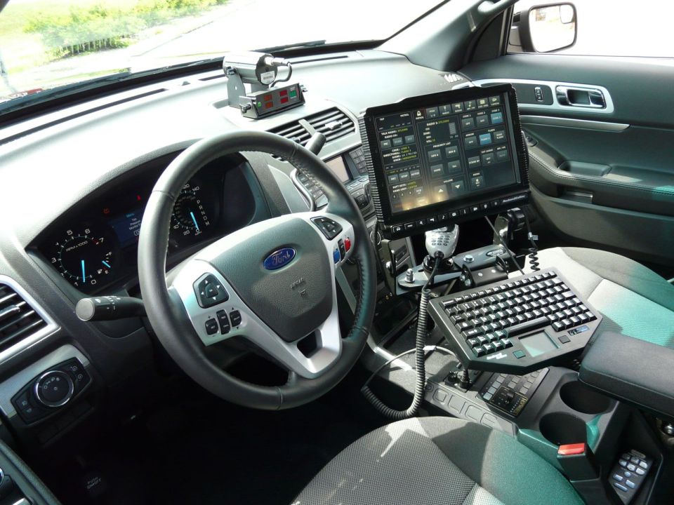 Police vehicle interior with touchscreen, keyboard, and Ford steering wheel
