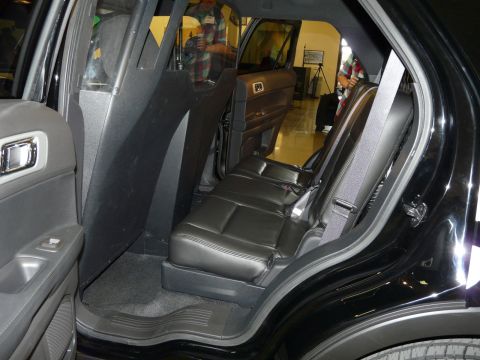 1993 Ford Taurus - The rear interior of a black SUV shows leather seats and a partition behind the front seats.