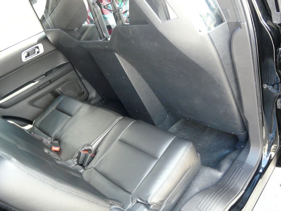 Interior view of police vehicle rear seats and partition