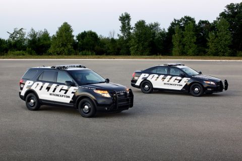 1993 Ford Taurus - A Ford Explorer Police Interceptor SUV and a Ford Taurus Police Interceptor sedan are shown from a three-quarter front view.