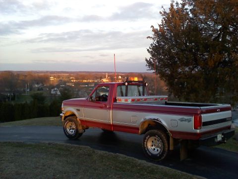 1996 Ford F-150 - This pickup truck has a toolbox in the bed and amber lights on the cab.