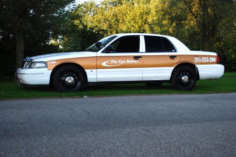 1998 Ford Crown Victoria - This 1998 Ford Crown Victoria taxi features a distinctive gold stripe and "Phil Taxi Service" branding.