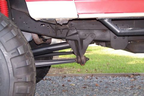 1990 Ford Bronco - Detail shot of the front suspension and tire on a Ford Bronco.