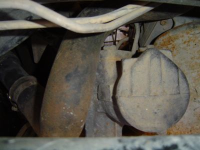 1995 Ford Bronco - Close-up view of a vehicle's steering gear box and associated plumbing.