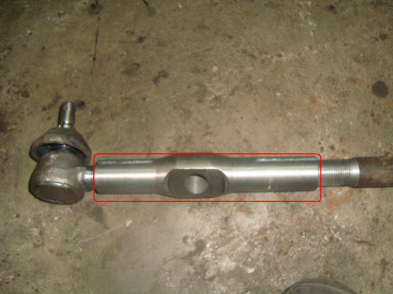 Metal tie rod end with a ball joint and threaded shaft, highlighted with a red box