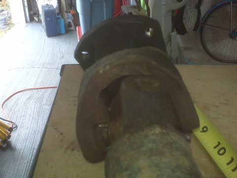 1991 Ford Bronco - Driveshaft universal joint shown with a measuring tape indicating its size.