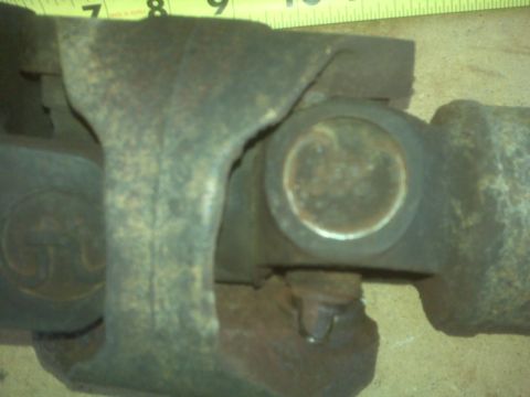 1991 Ford Bronco - Close-up view of a driveshaft universal joint, showing signs of rust and wear.