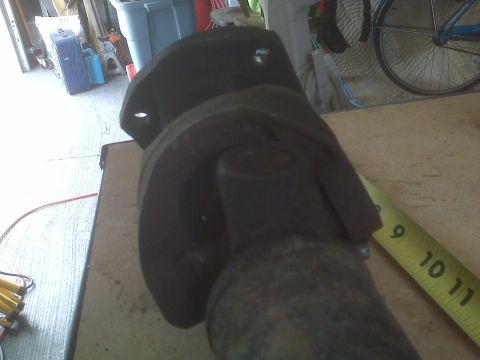 1991 Ford Bronco - Driveshaft part shown with a measuring tape, likely for repair or replacement.
