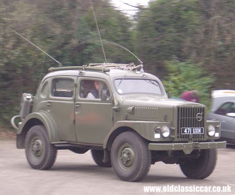 1995 Ford Bronco - This olive drab vehicle has a distinctive grille and dual antennas, suggesting a communication role.