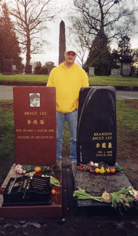 1981 Ford Bronco - A man poses for a photo in a cemetery, standing between the graves of Bruce Lee and Brandon Lee.