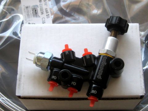 1996 Ford Bronco - A black Wilwood brake proportioning valve with red caps and a black adjustment knob is shown on a white box.