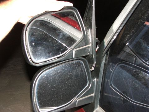 2003 Ford Sport Trac - Close-up of side mirrors being adjusted or replaced on a vehicle.