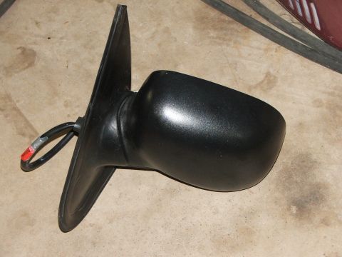 2003 Ford Sport Trac - A black side mirror with visible wiring is shown against a concrete background.