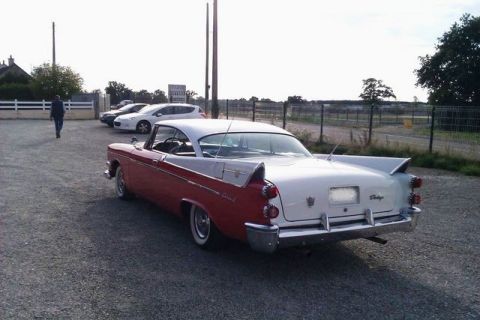 1991 Ford Crown Victoria - Rear view of a classic 1956 Dodge Coronet with distinctive tail fins.