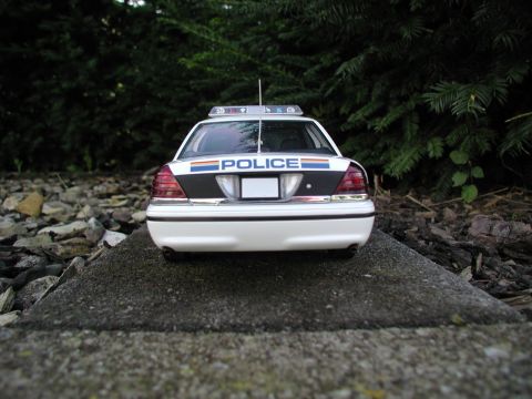 2001 Audi A4 - Model police car with 'POLICE' text on the trunk, set against a backdrop of trees and rocks.