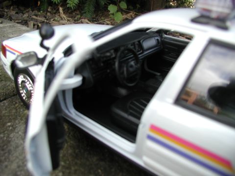 2001 Audi A4 - A close-up view of a white police car model's interior, showing the dashboard and seats.