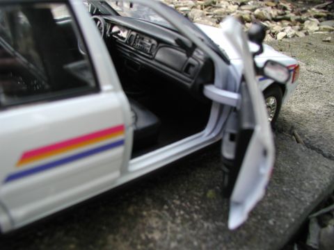 2001 Audi A4 - Interior view of a white police car model with its doors ajar, revealing the dashboard and distinctive side stripes.