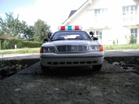 2001 Audi A4 - A police car with a light bar is parked on a concrete surface in front of a house.