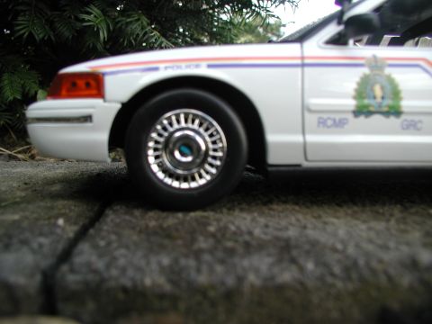 2001 Audi A4 - A white police car, possibly a model, is shown from the front quarter with "POLICE" and RCMP markings visible.