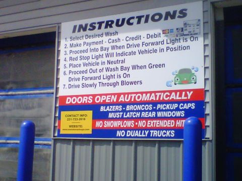 1995 Ford Bronco - An automatic car wash instruction sign mounted on a gray metal building, listing seven steps plus warnings that "Blazers - Broncos - Pickup…