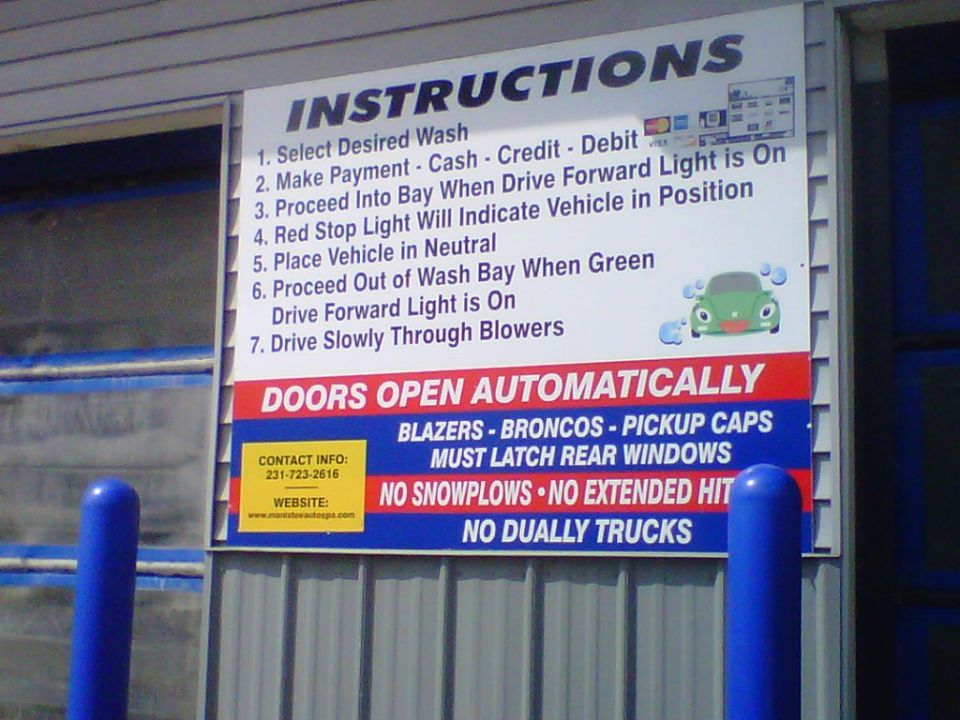 Car wash instruction sign warning Blazers, Broncos and pickup caps to latch rear windows