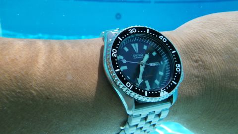 1996 Ford Bronco - A close-up of a Seiko automatic watch submerged in water.