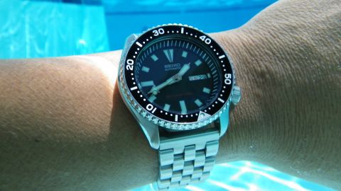 1996 Ford Bronco - A Seiko automatic dive watch is worn on a wrist submerged in blue water, with the bezel markings and dial details visible.