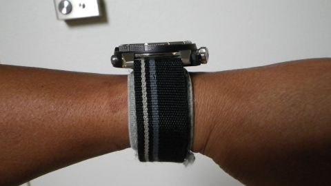 1996 Ford Bronco - A watch with a striped fabric band is worn on a wrist.