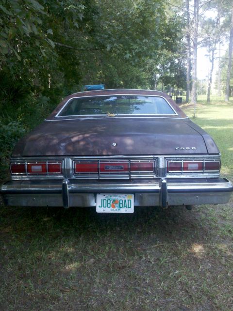 1974 Ford Elite - This Ford sedan, likely a 1977 model, is parked outdoors with trees in the background.