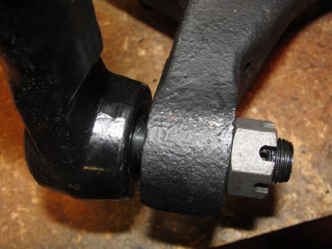 1995 Ford Bronco - A close-up view of a vehicle's steering linkage, a castle nut securing the joint.