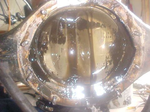 1996 Ford Bronco - Differential housing filled with old, dirty oil, likely needing service.
