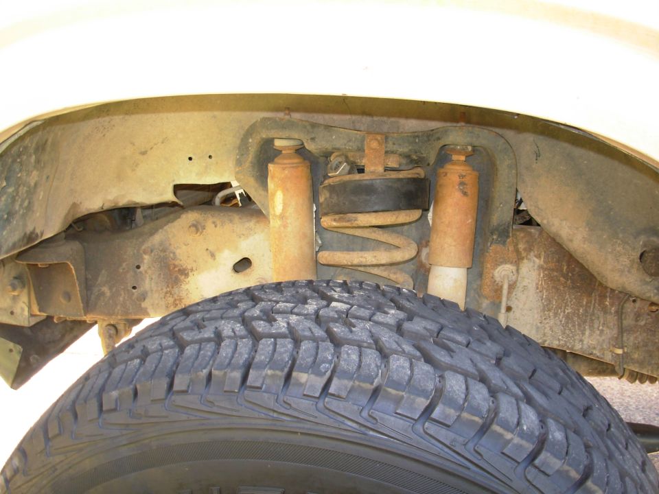 The rubber coil spacers went in a LOT easier than I expected, simply by jacking the frame until the front wheels came off the ground.  So for good measure, I put in some old twist lifters, but they're not holding much weight, either.  It's barely enough for the tires to clear without lifting the truck, but there's still a little grumble when I hit a hard bump, as the tread rubs the plastic wheelwell.