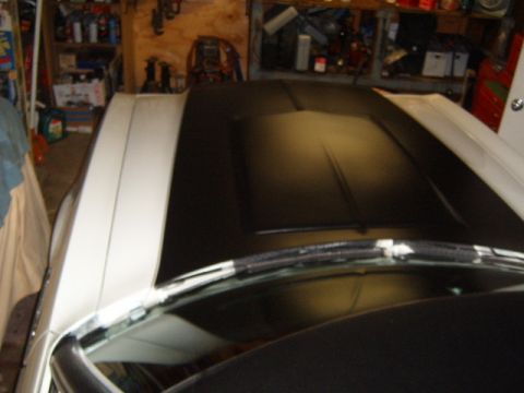 1973 Ford Ranchero - The hood of a 1973 Ford Ranchero shows a black vinyl top with white racing stripes, viewed from above.