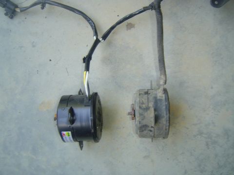 1994 Ford Crown Victoria - Comparison of two electric cooling fans, one new and one old, with their associated wiring.