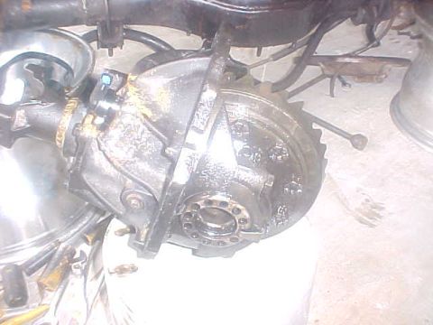 1996 Ford Bronco - Close-up view of a vehicle's rear differential, showing its internal components and metal casing.
