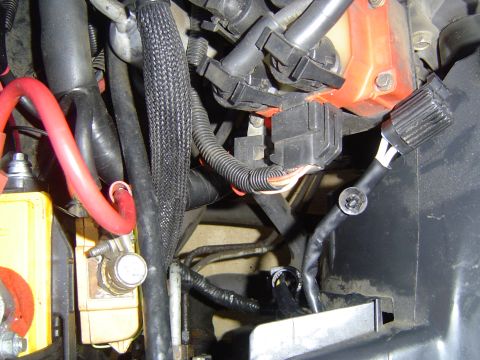 1994 Ford Crown Victoria - Close-up view of complex wiring and components within a vehicle's engine compartment.