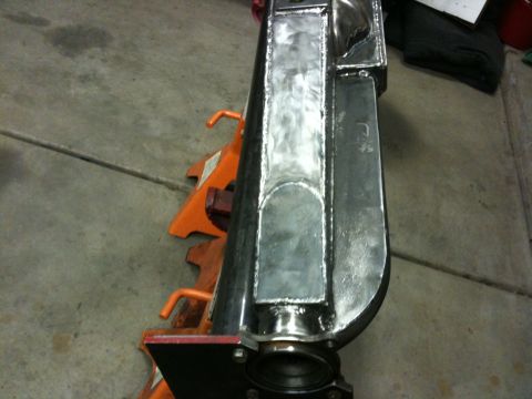 Suzuki Samurai - Modified rear axle housing supported by orange jack stands in a garage.