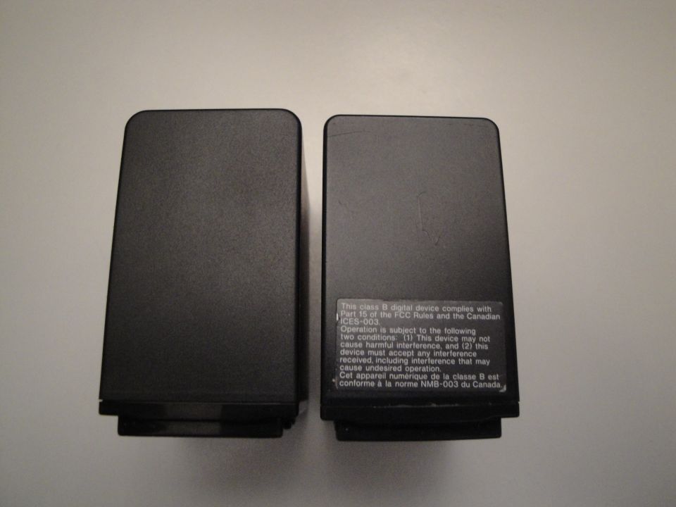 Two black speakers with FCC compliance text on the right one