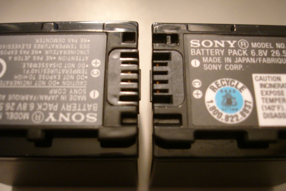 Two Sony battery packs side-by-side, showing their connection terminals