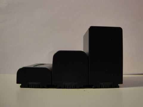 1993 Ford Taurus - Three black camera batteries of different sizes are arranged side-by-side against a plain background.