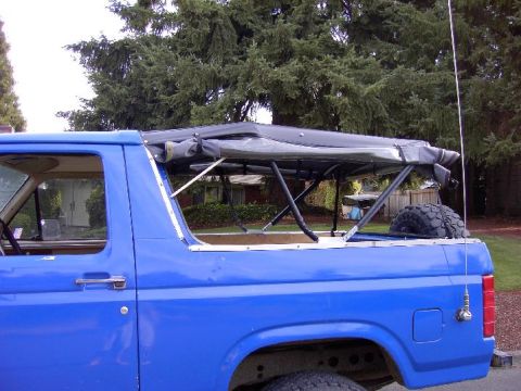 1980 Ford Bronco - Blue 1980 Ford Bronco showing the soft top frame and spare tire.