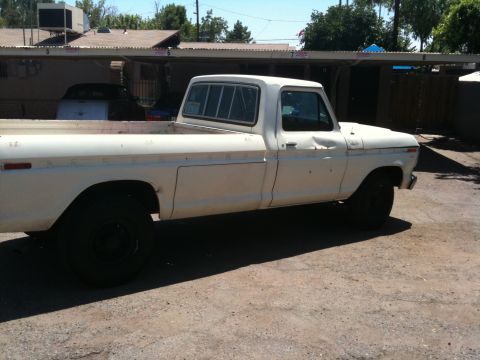 1979 Ford F-350 - This 1979 Ford F-350 pickup truck is seen from the side in a dusty lot.