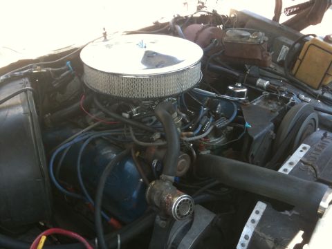 1979 Ford F-350 - The engine bay of a 1979 Ford F-350 shows its V8 engine with various components and wiring.